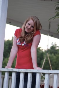 Daughter Lexie leaning on the porch railing.