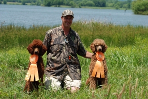 Reba and Cooper pictured with their rosettes.